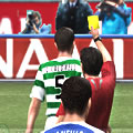 A referee shows a player a yellow card.